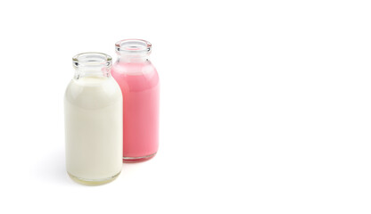 Two cocktail bottles of different colors isolated on a white background. Side view with space for copying. The concept of dairy products.