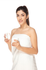 Obraz na płótnie Canvas Moisturizer. Beautiful female model isolated on white background. Beauty, cosmetics, spa, depilation, diet and treatment, fitness concept. Fit and sportive, sensual body with well-kept skin in towel.