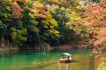 Fototapeta premium Arashiyama in autumn season along the river. Beautiful place to experience nature in Kyoto, Japan.