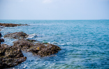 Ocean waves breaking on the rocks on the shore.