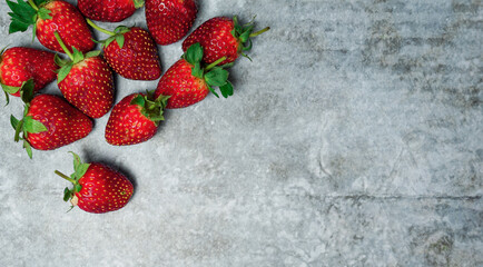 Strawberries on cement background with copy space.