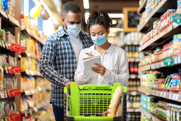 Black Couple Wearing Face Masks In Supermarket, Buying Groceries Indoors