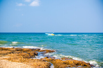 Ocean waves breaking on the rocks on the shore.