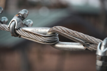 Two steel cables are fastened together by a special device .