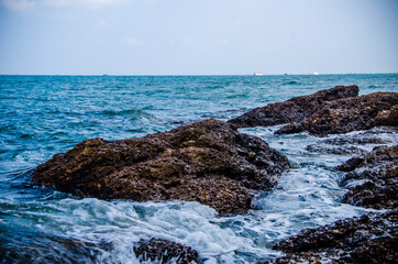 Ocean waves breaking on the rocks on the shore.