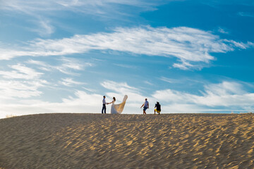 Wedding photographer taking pictures at the beach - Powered by Adobe