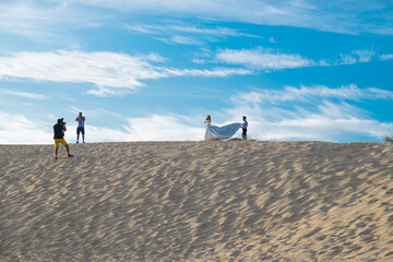 Wedding photographer taking pictures at the beach