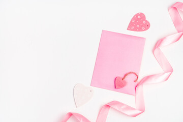 Hearts, ribbon and pink envelope on a light background. Top view with space to copy. The Concept Of Valentine's Day.