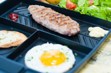 Breakfast, fried steak or cutlet, salad with tomato and green vegetables, toast, potato, egg closeup, light background. Concept healthy eating, diet, menu, nutritious food.