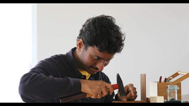 young man reparing a tool at home