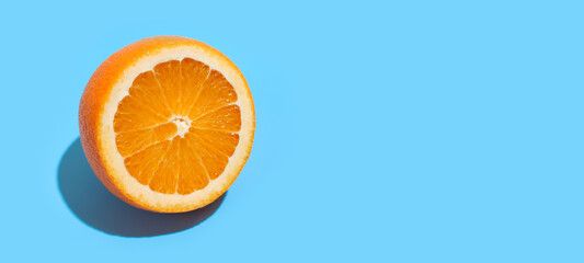 Ripe juicy delicious orange on blue background. Healthy eating and dieting concept