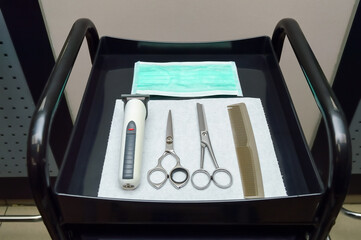 top view of hairdressing tools and disposable protective mask prepared for haircuts during pandemic...