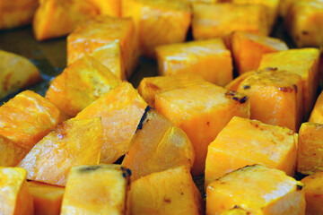 Roasting cubes of orange sweet potatoes