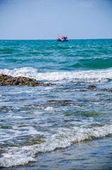 Ocean waves breaking on the rocks on the shore.