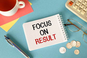 Focus on results is written on a notepad with office accessories.