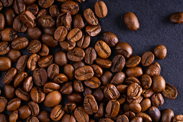 Obraz premium Coffee beans on dark background. Roasted coffee beans. Top view.