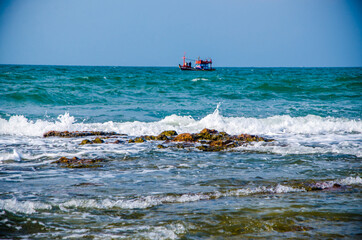 Ocean waves breaking on the rocks on the shore.