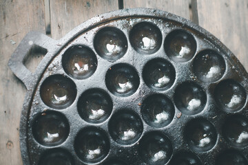 Pan for making Knmcrk on wood background