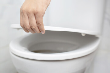 Modern bathroom ceramic toilet bowl with black background.