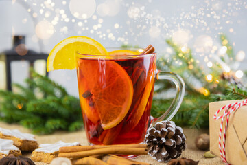 A glass of hot wine, mulled wine in a New Year's setting with bokeh in the background. Christmas, winter hot drink