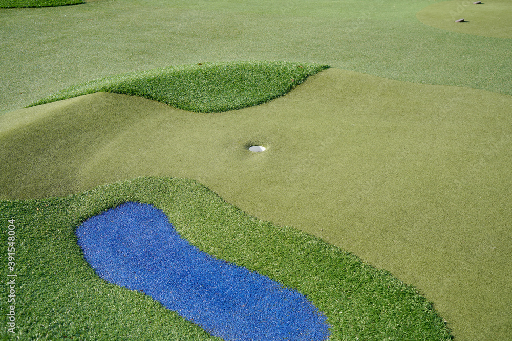 Sticker closeup of a golf field with different color sections and the ball hole