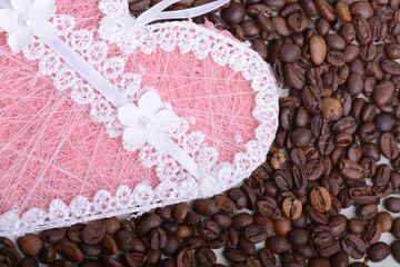 Coffee beans and love heart . Roasted aromatic brown coffee beans close up