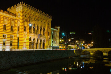 Fototapeta premium Historic town hall and National and University Library of Bosnia and Herzegovina in the city of Sarajevo at night. Bosnia and Herzegovina