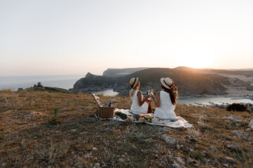 Two beautiful happy young friends on a picnic. The concept of communication, vacation, tourism