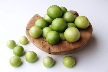Autumn vegetables still life composition. Tomatillo on a white background.Seasonal sale concept, no people.Concept of diet and healthy food.