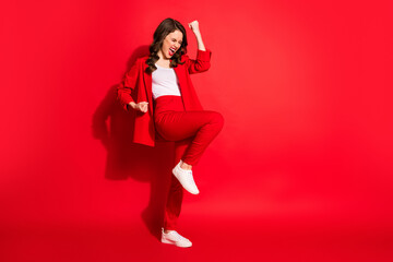Full length profile photo of lovely girl raise fists open mouth eyes closed wear blazer pants footwear isolated red color background - obrazy, fototapety, plakaty