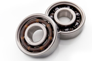 Heavy industry, friction reducing gear, metallic machinery parts and moving mechanism concept with two chrome ball bearings isolated on white background