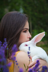 pretty girl holding a white bunny - 391554021