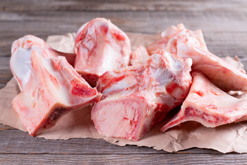 Raw beef bone for making broth on wooden background