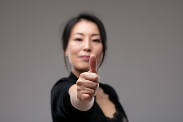 Successful motivated woman giving a thumbs up