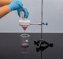 Filter paper in laboratory. Scientists are chemical filtration by filtering through filter paper in...
