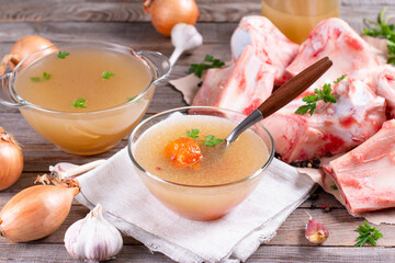 Homemade beef bone broth with natural collagen. Bouillon in glass dish