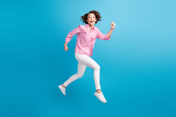 Full size photo of crazy girl jump run fast wear pink clothes isolated over blue pastel color background
