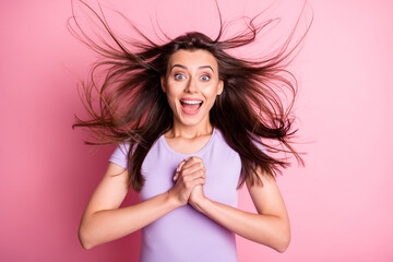 Portrait of inspired impressed girl hold crossed palms on heart open mouth flowing hair wear purple t-shirt isolated on pink color background