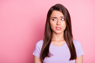 Portrait of emotional young woman girl feel disgust look empty space dressed violet t-shirt isolated on pink color background