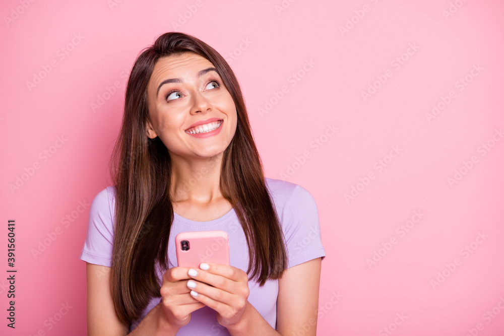 Canvas Prints Photo of happy enjoyed young lady hold phone look empty space wear purple t-shirt isolated on pink color background