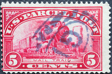 USA - Circa 1912 : a postage stamp printed in the US showing a steam locomotive with wagons Text:...
