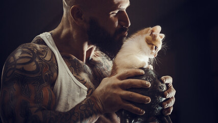 brutal tattooed man with cat