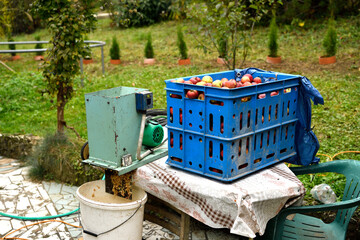 Crate with autumn apples and pulp in a bucket