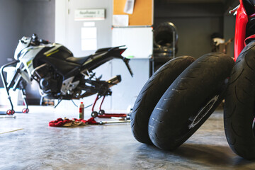 closeup motorcycle tire bigbike in garage with soft-focus and over light in the background