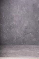 gray desk table or shelf near grey concrete wall