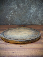 pizza cutting board at wooden table