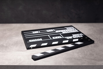 movie clapper board or clapperboard at table