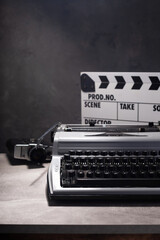 vintage typewriter, camera and movie clapper board