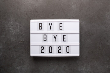 Lightbox with text BYE BYE 2020 on dark stone background. Top view. New year celebration. Happy New Year 2021 concepts