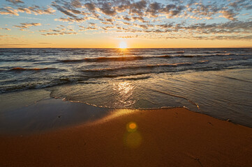 sunset on the sandy beach of the gulf of finland